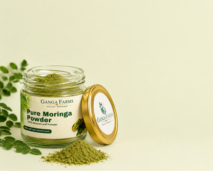 Jar of Ganga Farms Pure Moringa Powder with a light green background
