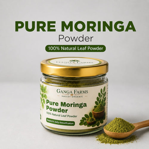 Jar of Ganga Farms Pure Moringa Powder with a scoop of powder on a light background